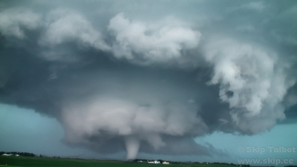 A stovepipe tornado (bottom) develops beneath a dramatic wall cloud (middle) and mesocyclone (top)